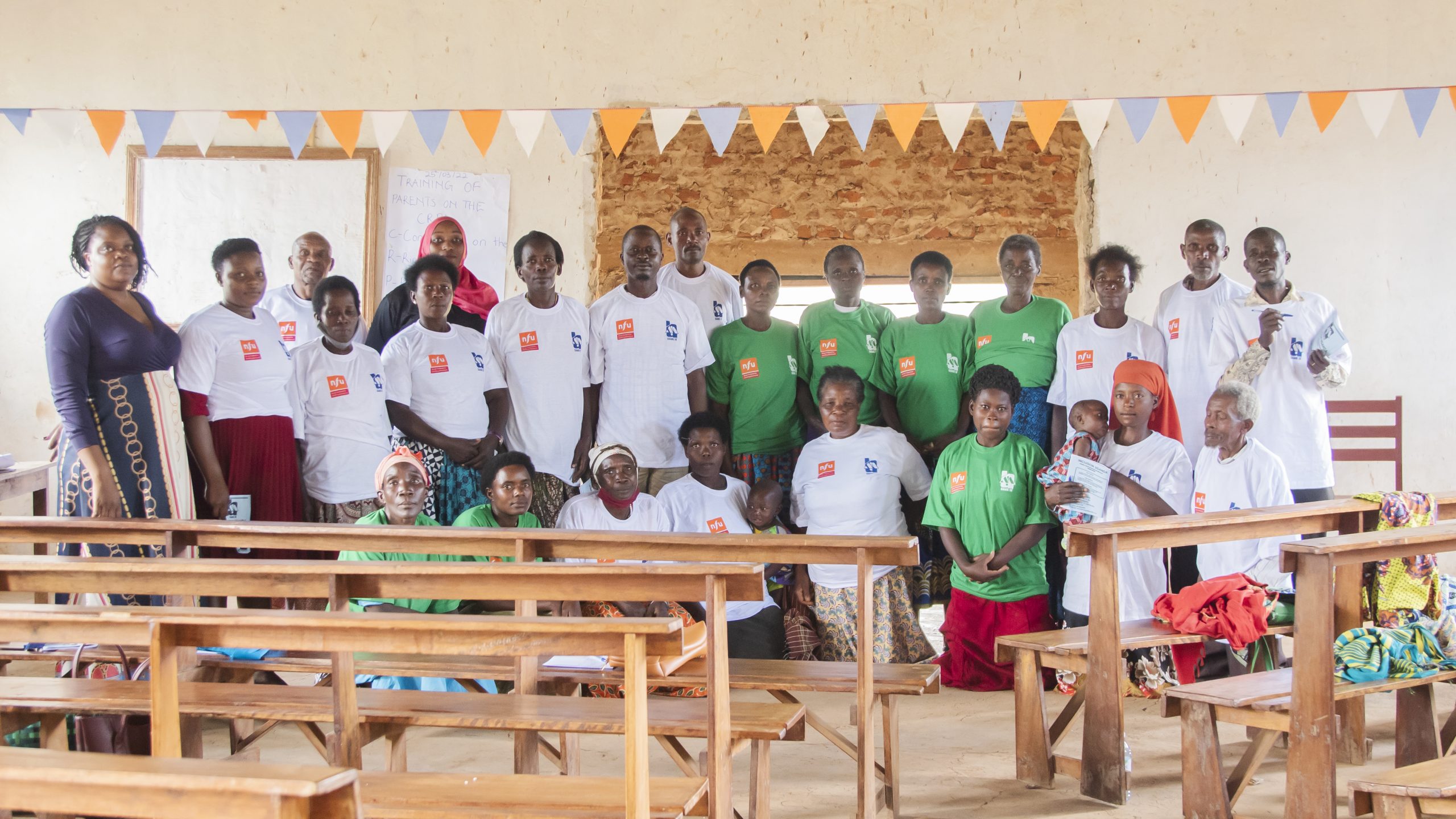 Parents in Rubindi, Mbarara pose for a photo after a training session